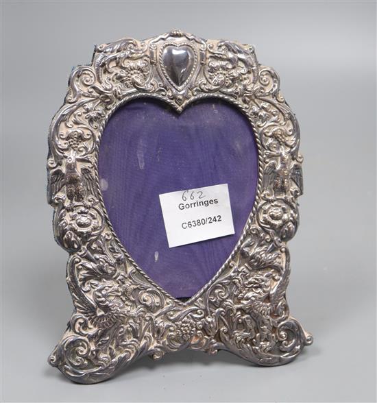 A 1970s Victorian style silver photograph frame with a heart shaped aperture, 19.4cm.